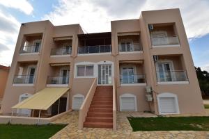 a building with a staircase in front of it at Flisvos Rooms in Palaiochora