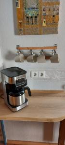a coffee maker on top of a wooden table at Ferienhaus Cornelia in Koblenz