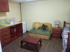 a living room with a couch and a table at Hospedaje Wiruyana in Cotacachi