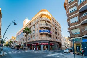 a tall building on a city street with a street sign at apartamento Sunrise Apolo in Torrevieja
