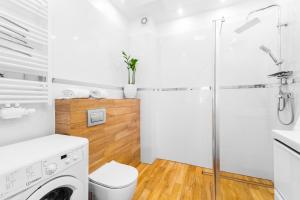 a white bathroom with a washing machine and a shower at Apartament Rowerowo przez Mierzeję, rowery gratis in Sztutowo +16 photos