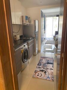 a kitchen with a washing machine and a rug at G-Cribs gouna in Hurghada