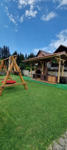 a park with a picnic table and a playground at Freemont in Braşov