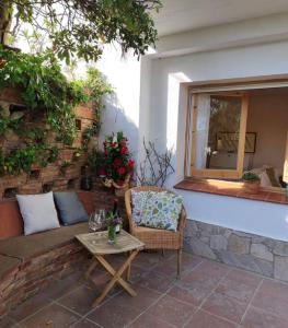 a patio with a couch and a table and a window at Apartament 'Es Botànic' in Blanes