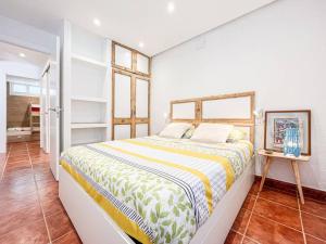 a bedroom with a large bed in a room at Apartament 'Es Botànic' in Blanes
