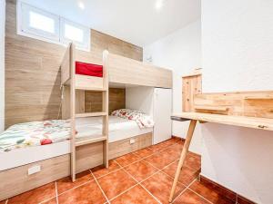 a small bedroom with a bunk bed and a desk at Apartament 'Es Botànic' in Blanes