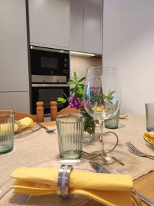 a table with glasses and a napkin on it at Apartament 'Es Botànic' in Blanes