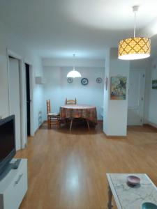 - un salon avec une table et une salle à manger dans l'établissement APARTAMENTOS RAMÓN, à Foz