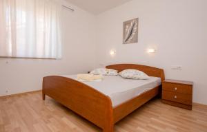 a bedroom with a bed with two towels on it at Apartments Silvana in Kampor in Kampor
