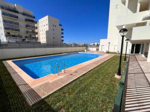 a swimming pool on the side of a building at Penthouse sea view in Oliva