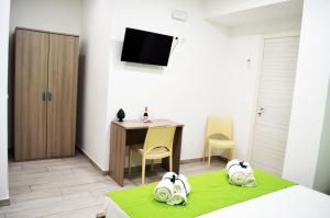 a bedroom with a desk and a bed and a table at Casa Canali in Palermo