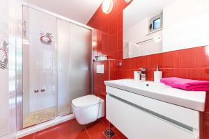 a bathroom with a toilet sink and a shower at Rajcic Apartments in Rogoznica +68 photos