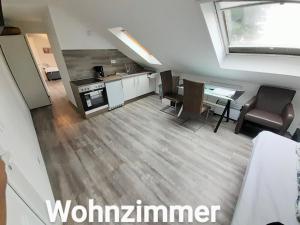 uma cozinha e sala de estar com mesa e cadeiras em FMI Apartment LST Next to Airport em Rüsselsheim