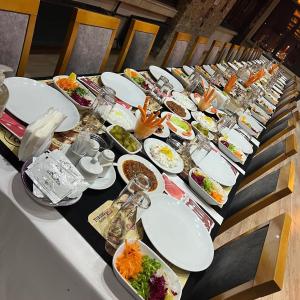 a long table with plates of food on it at KOLAĞASI HOTEL in Corum