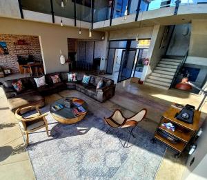 an overhead view of a living room with a couch and chairs at Dolphin Beach Villa at 138 Oystercatcher, Swakopmund in Rand Rifles
