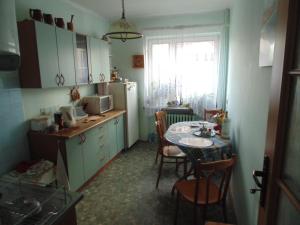 a kitchen with a table and a dining room at Villa Turysta in Białystok