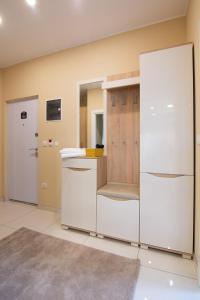 a kitchen with a counter and a white refrigerator at Jana apartmani in Novi Grad