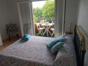 a bedroom with a bed and a view of a patio at El Refugio in Calatayud