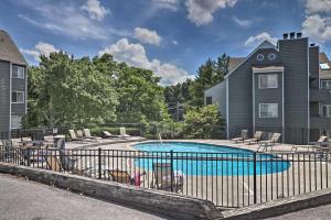 a house with a swimming pool in front of a house at Cozy Resort-Style Condo Less Than 2 Mi to Ober Gatlinburg! in Gatlinburg