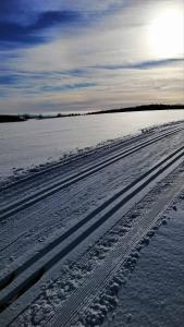 a snow covered field with tracks in the snow at Ubytování Vlachovice u Nového Města na Moravě in Nové Město na Moravě +3 photos