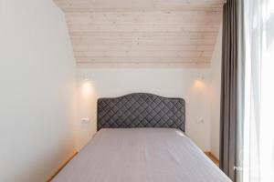 a bedroom with a bed in a room at Čiki Puki Pajūrys in Palanga +26 photos