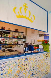 a kitchen with a counter with a crown on the wall at Hotel Regina del Mare in Ischia
