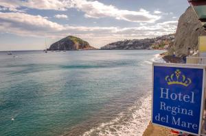 a sign for a hotel reina del mar on a beach at Hotel Regina del Mare in Ischia