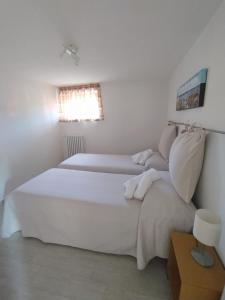 a bedroom with two beds and a window at Appartamento Le Ancore in Marciana Marina