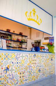 a counter in a restaurant with a sign on the wall at Hotel Regina del Mare in Ischia