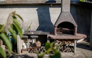 a outdoor oven with a sink next to it at Apartments Silvana in Kampor in Kampor