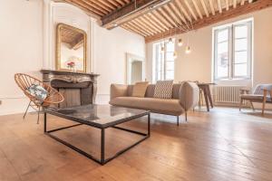 a living room with a couch and a chair and a fireplace at Spacious apartment Rated 4 stars in the heart of the old town in Annecy