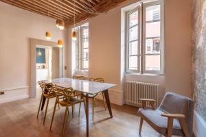 a dining room with a table and chairs at Spacious apartment Rated 4 stars in the heart of the old town in Annecy