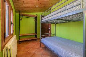 a bedroom with two bunk beds and green walls at Cal Carol in Vallcebre