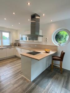 a kitchen with a large island with a counter top at Ferienhaus Xantenamera in Xanten-Wardt am See in Xanten