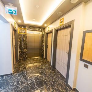 a hallway of a hotel with a marble floor at ÇAMLICA PARK OTEL in Of +4 photos