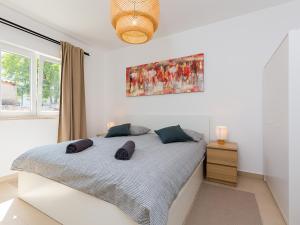 a bedroom with a bed and a painting on the wall at Apartment Anna in Poreč