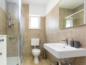a bathroom with a sink and a toilet and a shower at Apartment Anna in Poreč +14 photos