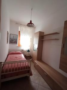a bedroom with a red bed and a window at Il Poggio in Murlo