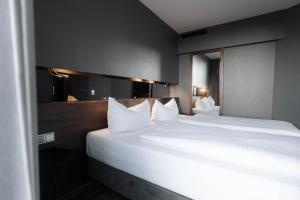 Кровать или кровати в номере Hotel am Augustinerplatz