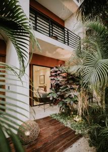 a house with a bunch of plants in a room at The Strabon Tulum in Tulum