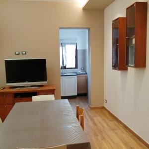 uma sala de estar com uma mesa e uma televisão em Ivana home em Trapani