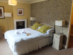 a bedroom with a bed with two towels on it at The Red Lion, Stretham in Ely