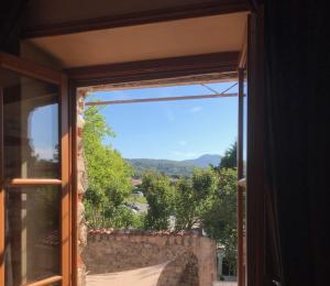 a window with a view of a mountain at La LAZARENCO in Plan-de-la-Tour +9 photos