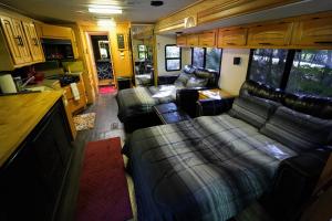 a living room with couches and a couch in an rv at 3E *Glamping at Treasure Lake* in DuBois