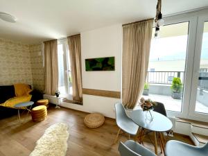 a living room with a table and chairs at Strešný Aparmán Pri Mlyne in Skalica