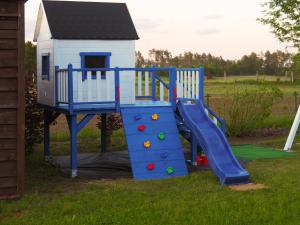 a playground with a slide in the grass at Agroturystyka Iwona Jażdżewska in Osława Dąbrowa