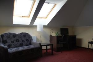 a living room with a couch and two windows at Rogatka in Rogówko