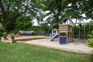 a playground with a slide and a slideintend at Lower Trengale Farm Holiday Cottages in Liskeard