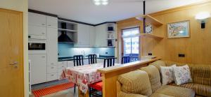 a kitchen with a couch and a table in a room at Bait da Marieta in Livigno
