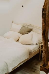 a bed with white sheets and pillows on it at Modernisiertes Fachwerkhaus in Rheinbach bei Bonn in Rheinbach